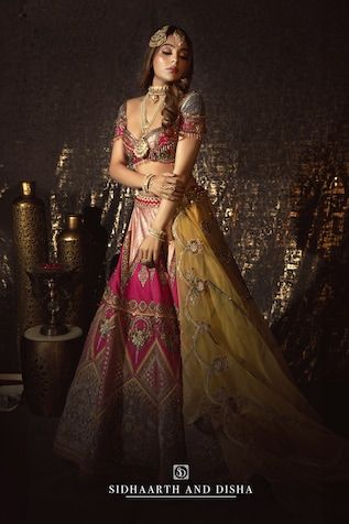 Rani pink flared lehenga with Bahar mahal embroidery using resham thread, zari, mirror highlights. Paired with a half sleeves deep sweetheart neck blouse with floral embroidery using resham thread, zari highlights, dangling glass beads and a contrasting yellow scallop border floral embroidered organza dupatta. - Aza Fashions Pink Chandbali Choli For Eid, Pink Lehenga With Cutdana For Eid, Pink Sharara For Navratri, Pink Cutdana Lehenga For Eid, Pink Anarkali Choli With Cutdana, Designer Pink Lehenga With Sheer Dupatta, Pink Sharara For Reception Navratri, Pink Sharara For Reception And Navratri, Designer Pink Lehenga With Cutdana Detail