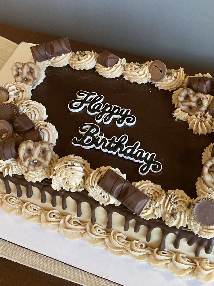 a birthday cake with chocolate frosting and decorations