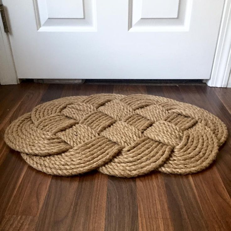 a door mat on the floor in front of a white door