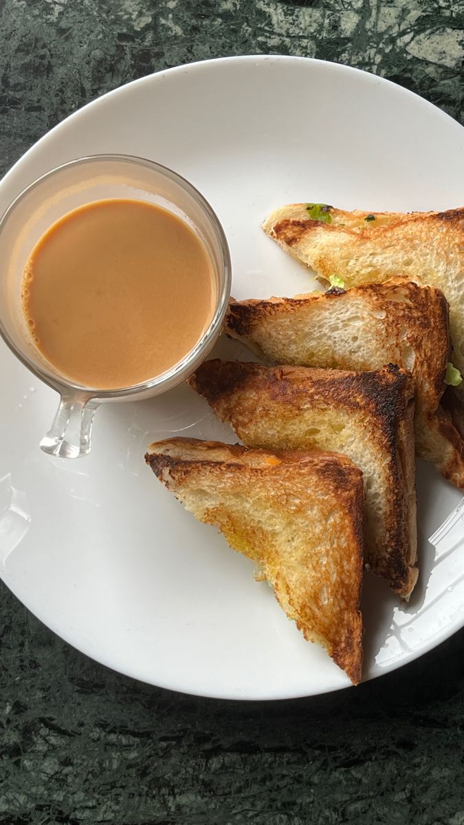 four pieces of toast on a plate with dipping sauce