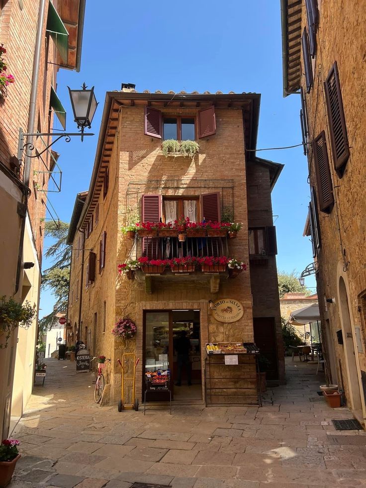 an old building with flowers on the balconies