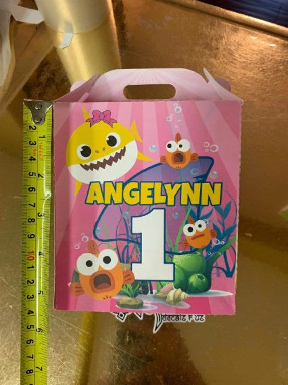 a pink box with an image of the number one monster on it and a measuring tape