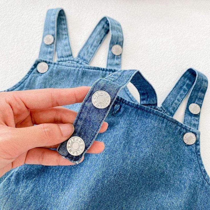 A denim bodysuit never goes out of style. Dress her up in this denim bodysuit featuring super soft denim fabric. This bodysuit includes an elastic openings at the legs and closure button straps to ensure a comfy fit perfect for any warm weather occasion. Pair with a cute denim hat or ruffle neck long sleeve on cooler days, for a complete outfit. Make your baby more lovely. Great for daily wear, birthday party, or baby photography. Material: COTTON Collar: O-Neck Item Type: Bodysuits Sleeve Lengt Medium Wash Cotton Denim Jumpsuit With Button Closure, Casual Spring Bodysuit With Button Closure, Dark Wash Buttoned Cotton Denim Jumpsuit, Light Wash Denim Overalls With Button Closure, Spring Medium Wash Denim Jumpsuit With Suspenders, Casual Blue Cotton Bodysuit, Cotton Jumpsuits And Rompers With Buttons In Medium Wash, Casual Bodysuit With Buttons For Spring, Casual Spring Bodysuit With Buttons