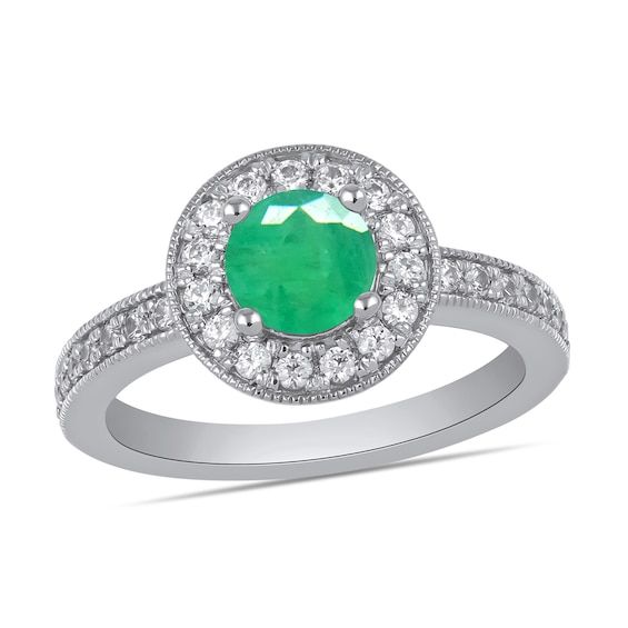 an emerald and diamond ring with white diamonds on the band, set in 18k white gold