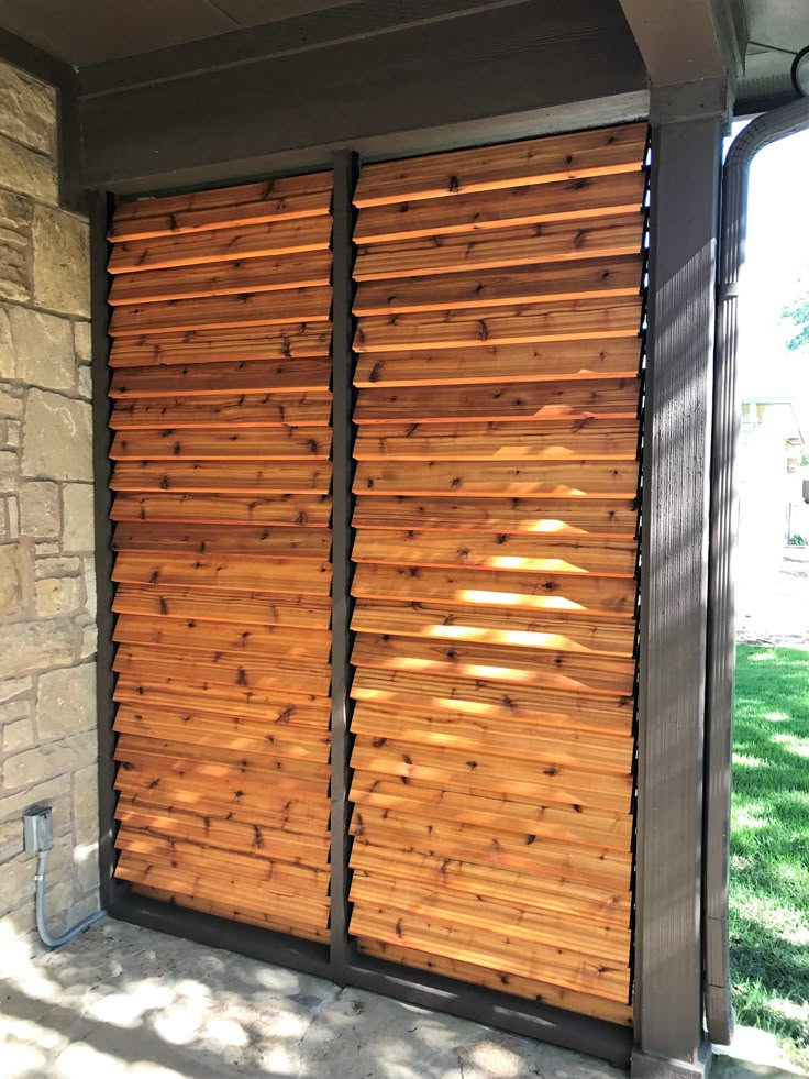 a large wooden sliding door on the side of a building