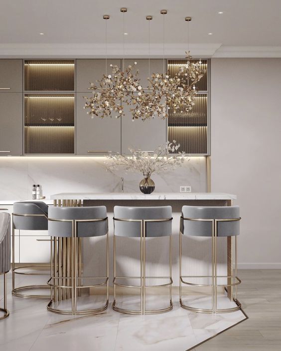 a modern kitchen with marble counter tops and bar stools