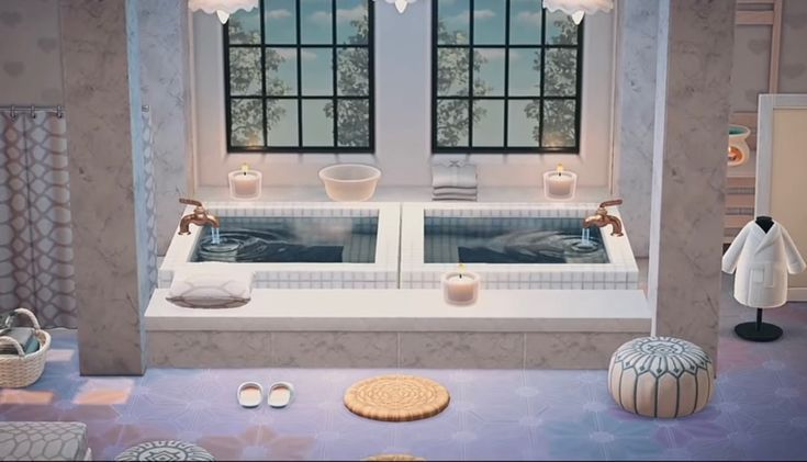 a bathroom with two sinks and candles on the windows sill, in front of a large window