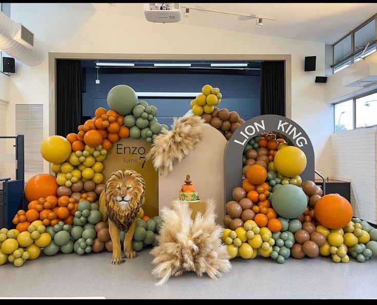 an animal made out of fruits and vegetables in front of a lion king sign on display