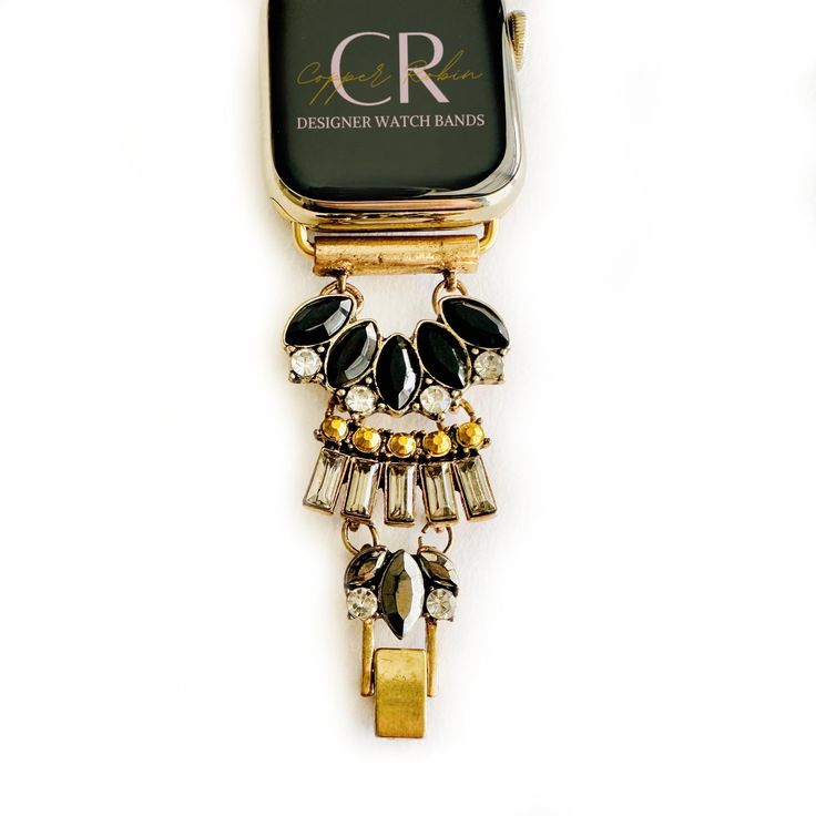 Dress up your everyday look with one of our custom-made jewelry watch bands! This is sure to be a gift that will please the girl who has everything or maybe just wants everything. This Multi-toned gold, black onyx and crystal statement bracelet Apple Watch Band is one of Copper Robin's best-selling bands. Available in Apple watch sizes 38mm, 40mm, 41mm, 42mm, 44mm, 45mm, 46mm, and 49mm It will fit all series of apple watches. Series 1-10 and SE. Available in Rose Gold, Gold, and Silver. Sizing: Luxury Adjustable Jewelry With Custom Hardware, Modern Black Watch Bands As Gift, Elegant Gold Apple Watch Band As Fashion Accessory, Luxury Black Jewelry And Watches As Gifts, Adjustable Gold Jewelry With Black Band, Elegant Metal Watch Bands As Gift, Timeless Adjustable Black Jewelry, Adjustable Metal Elegant Watch Bands, Trendy Black Watch Bands For Fashion Accessory