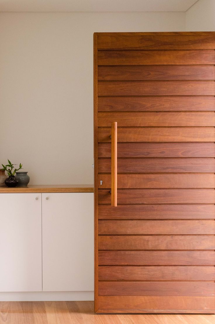 a kitchen with wooden doors and white cabinets