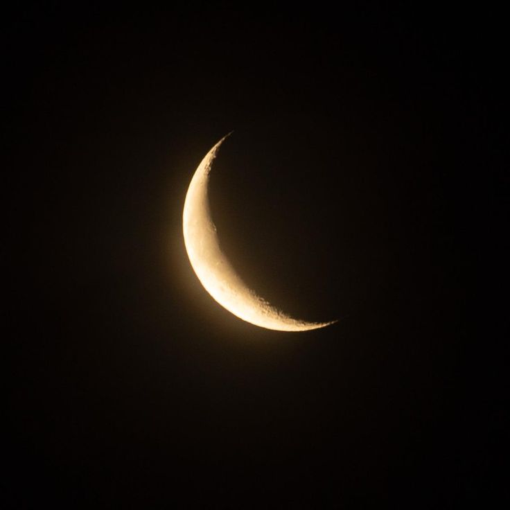 the moon is seen in the dark sky with only one light on it's side