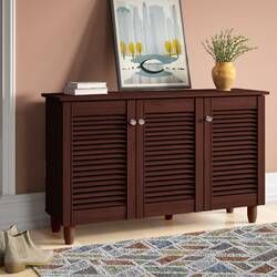 a wooden cabinet with shutter doors in a living room