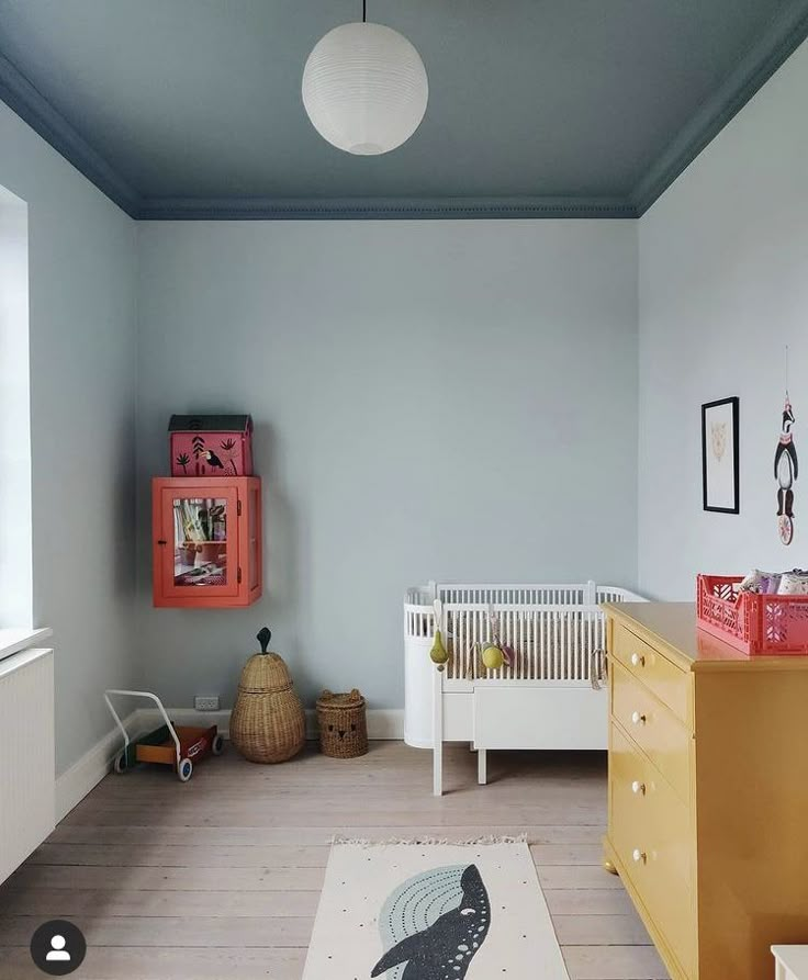 a baby's room with two cribs, dresser and other furniture in it