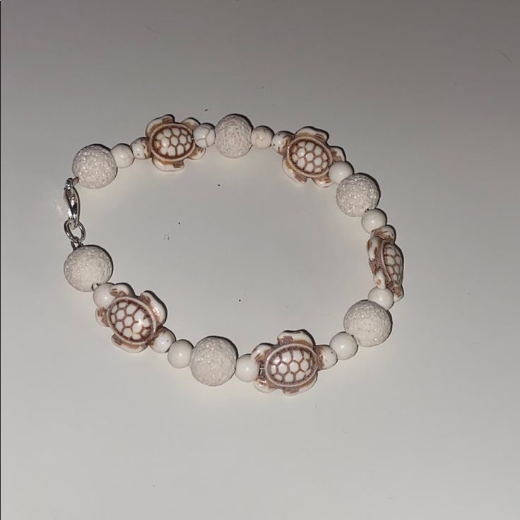 White And Brown Turtles With White Coral Beading Lobster Clasp Opened Length About 8.5” Closed Diameter About 3” White Beads Bracelet, Spike Bracelet, Best Friend Bracelets, Hair Tie Bracelet, Turtle Bracelet, Sister Bracelet, Circle Bracelet, Swarovski Crystal Bracelet, Friend Bracelets