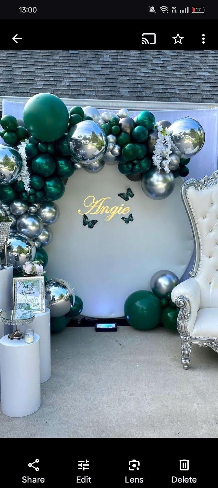 a room decorated with balloons and furniture for a wedding or special event in green, silver and white