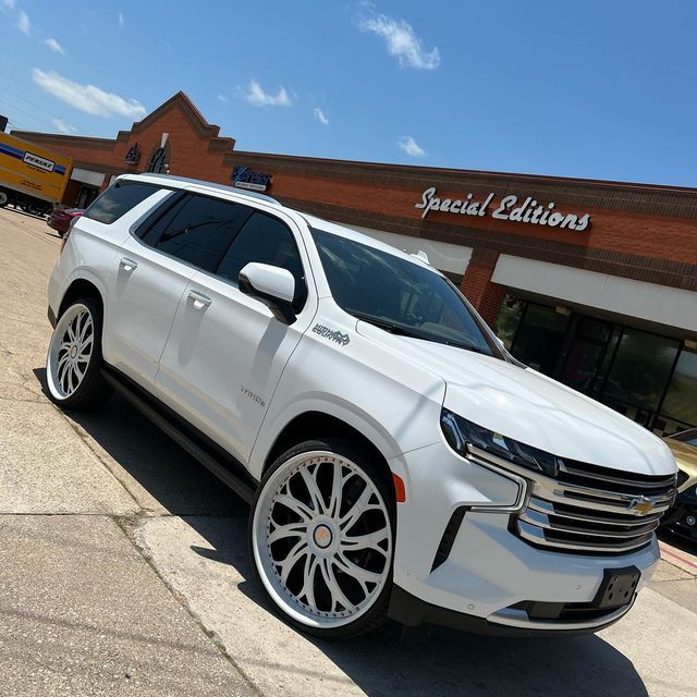 a white suv parked in front of a store