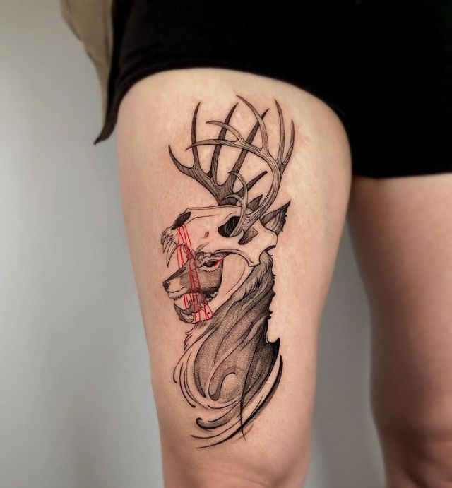 a woman with a deer tattoo on her thigh