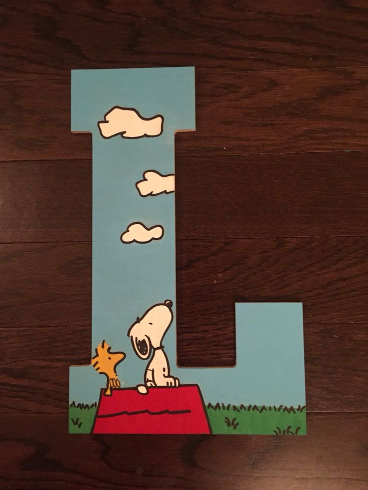 the letter l is made to look like a snoopy dog on top of a hill