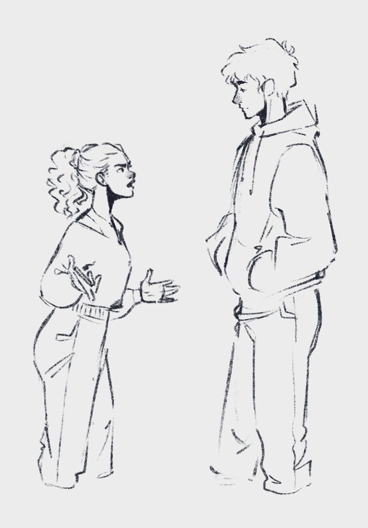 two people standing next to each other talking