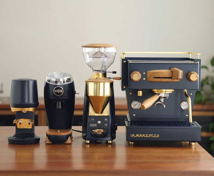 three different types of espresso machines sitting next to each other on a table