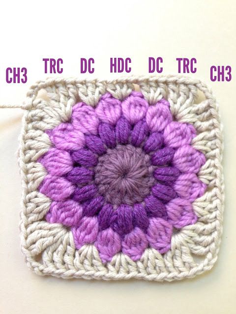 a crocheted square with a purple flower on it and the words ch3