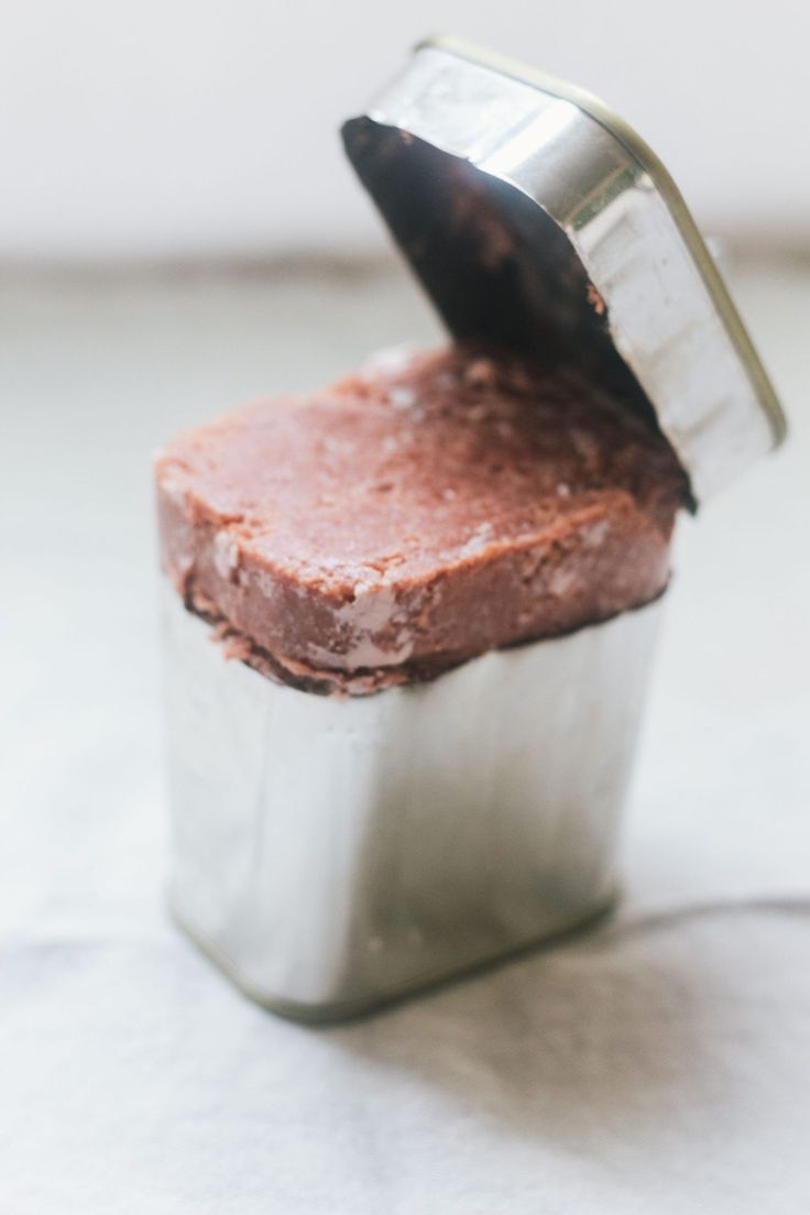 a piece of cake in a tin with a spatula sticking out of the top