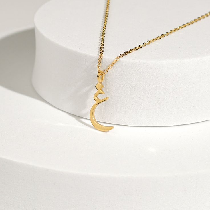 This stunning necklace features a beautifully crafted pendant with a personalized Arabic letter. The elegant design of the letter captures its unique and intricate beauty, making it a focal point of sophistication and charm. The pendant hangs from a delicate chain, perfect for adding a touch of elegance to any outfit. Ideal for everyday wear or special occasions, this necklace makes a meaningful and stylish statement. It also serves as a thoughtful and personalized gift for loved ones, celebrati Elegant Initials Pendant Jewelry, Elegant Monogram Initial Pendant Necklace, Elegant Monogram Charm Necklace, Elegant Monogram Charm Necklace For Personalized Gift, Elegant Initial Necklace With Monogram Round Pendant, Elegant Sterling Silver Monogram Charm Necklace, Elegant Initial Pendant Name Necklace For Mother's Day, Elegant Sterling Silver Initials Charm Necklaces, Delicate Initial Pendant Necklace For Her