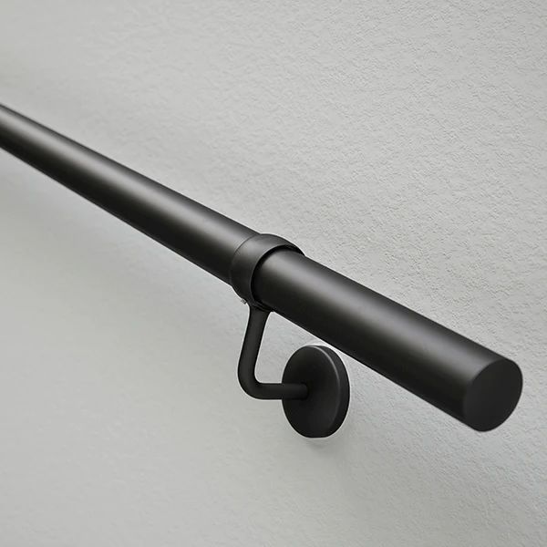 a black metal curtain rod on a white wall