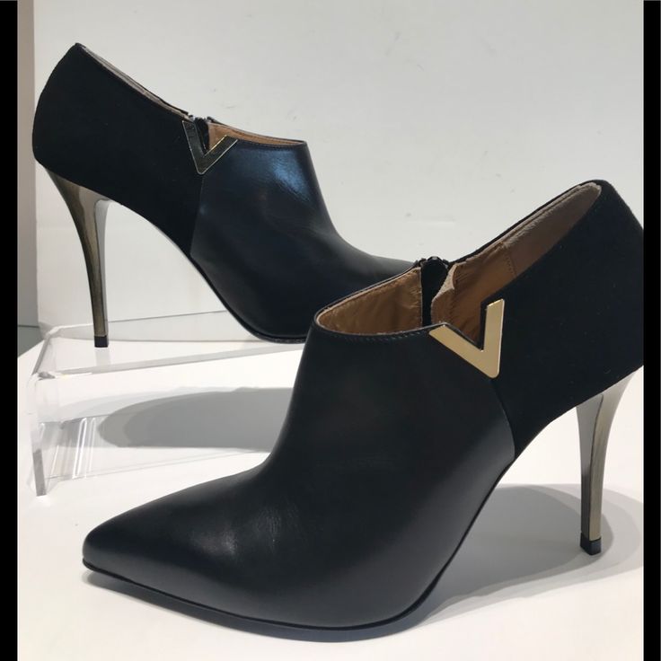 Gianni Ferrante Black Hh Gold Finish On The Heel Ankle Bootie With V Detail On The Side .Inside Zipper Easy To Get On ...Rubber Bottom For Comfort .Looks Great With Dresses And Skirts Because The Cute Of The Bootie On The Leg . Formal High Heel Boots With Contrasting Heel Counter, Chic Heeled Boots With Contrasting Heel For Evening, Formal Heeled Boots With Ankle Strap And Reinforced Heel, Formal Ankle-high Heels With Contrasting Heel Counter, Modern Ankle-high Evening Heels, Formal Ankle Boot With Sculpted Heel, Elegant Black Pointed Toe Heeled Boots, Chic Formal Heeled Boots With Metal Feet, Evening Ankle-high Boots With Contrasting Heel Counter