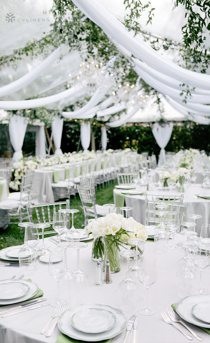 the tables are set with white and green linens