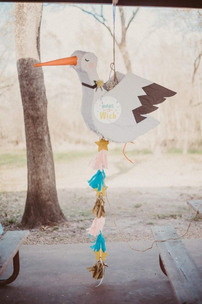 a stork mobile hanging from a tree