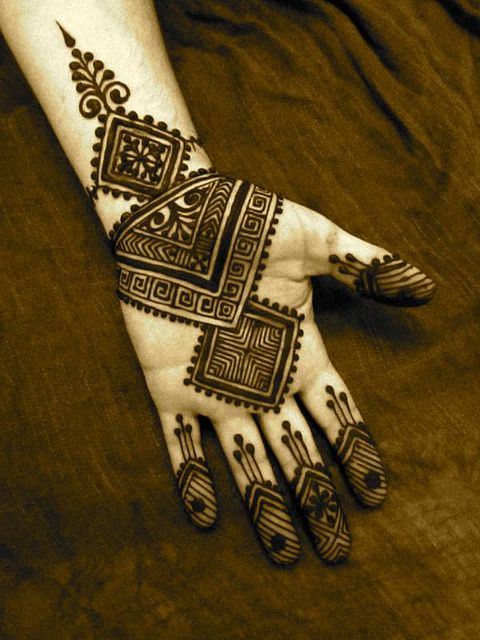 a henna on someone's hand with intricate designs