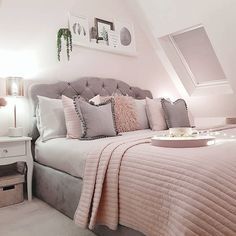 a bedroom with a bed, nightstands and pictures on the wall