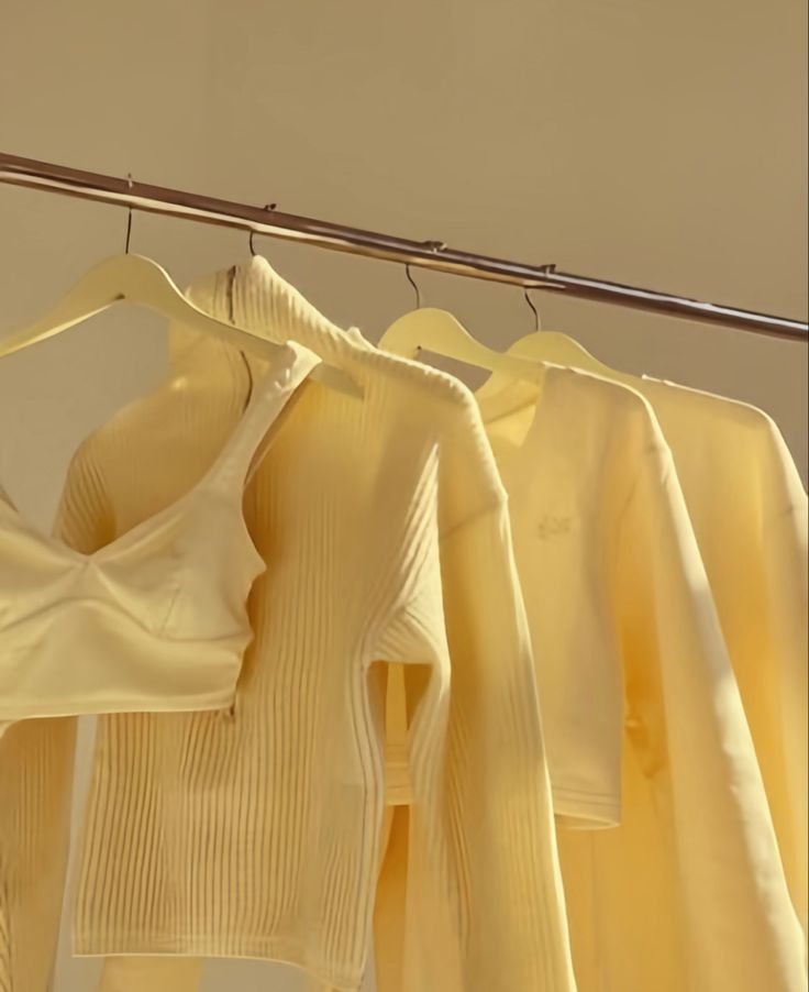 three white shirts hanging on a clothes line