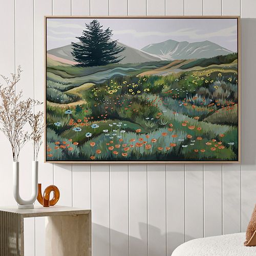 a painting hanging on the wall above a bed