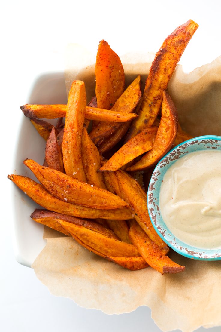 some fries and dip in a bowl on a table