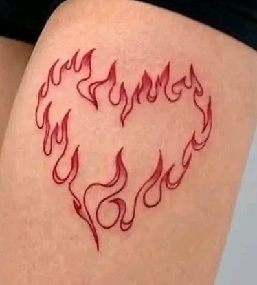 a woman's thigh with red flames drawn on it and the shape of a heart