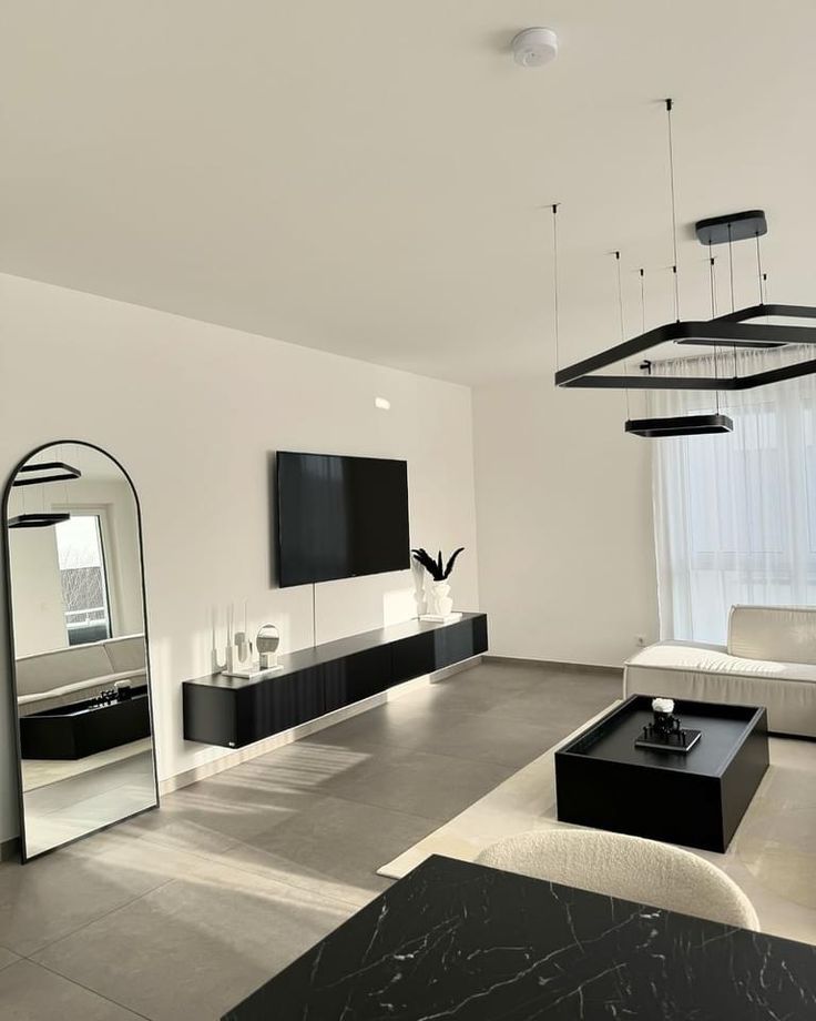 a modern living room with black and white furniture