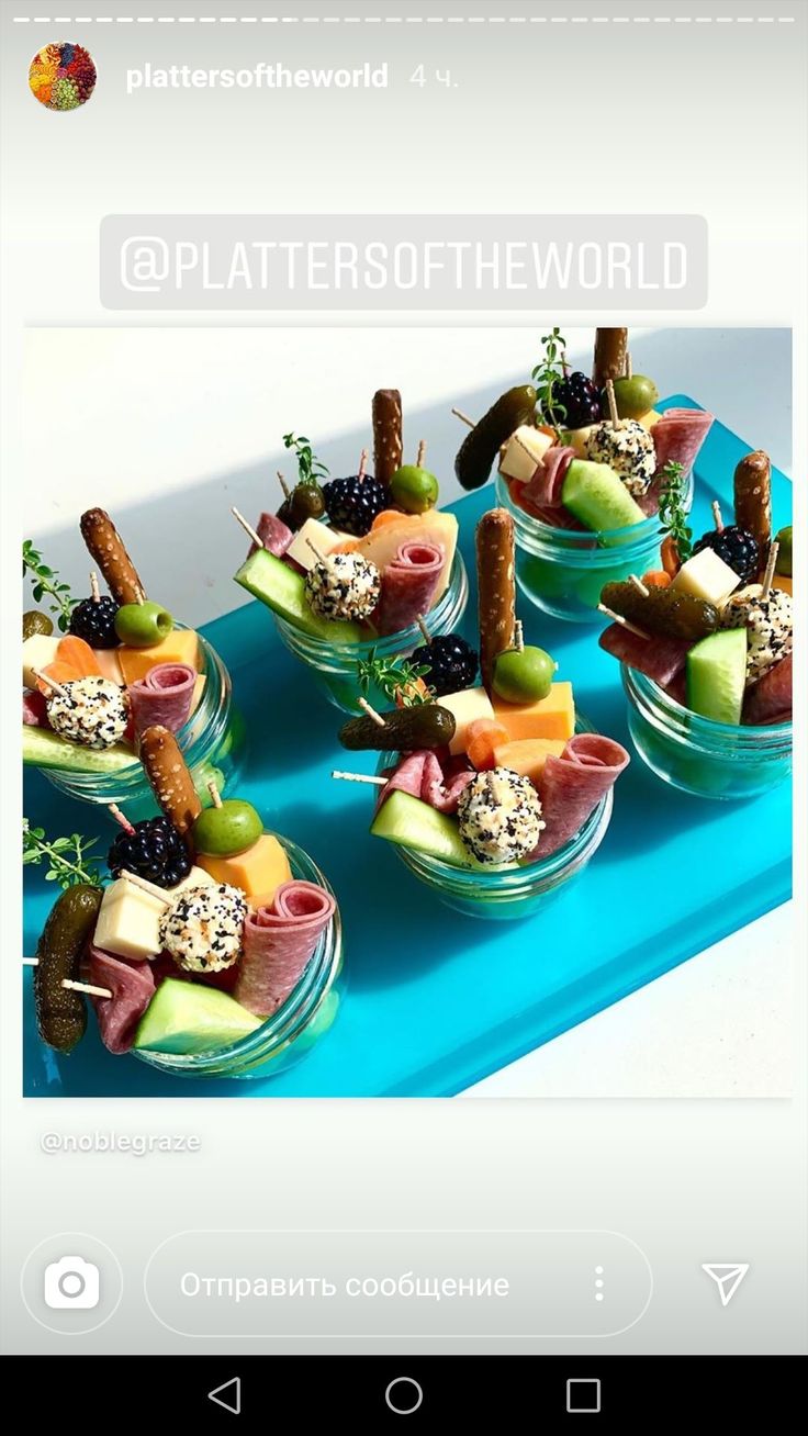 there are many appetizers in small glass bowls on the blue trays that each have different types of appetizers