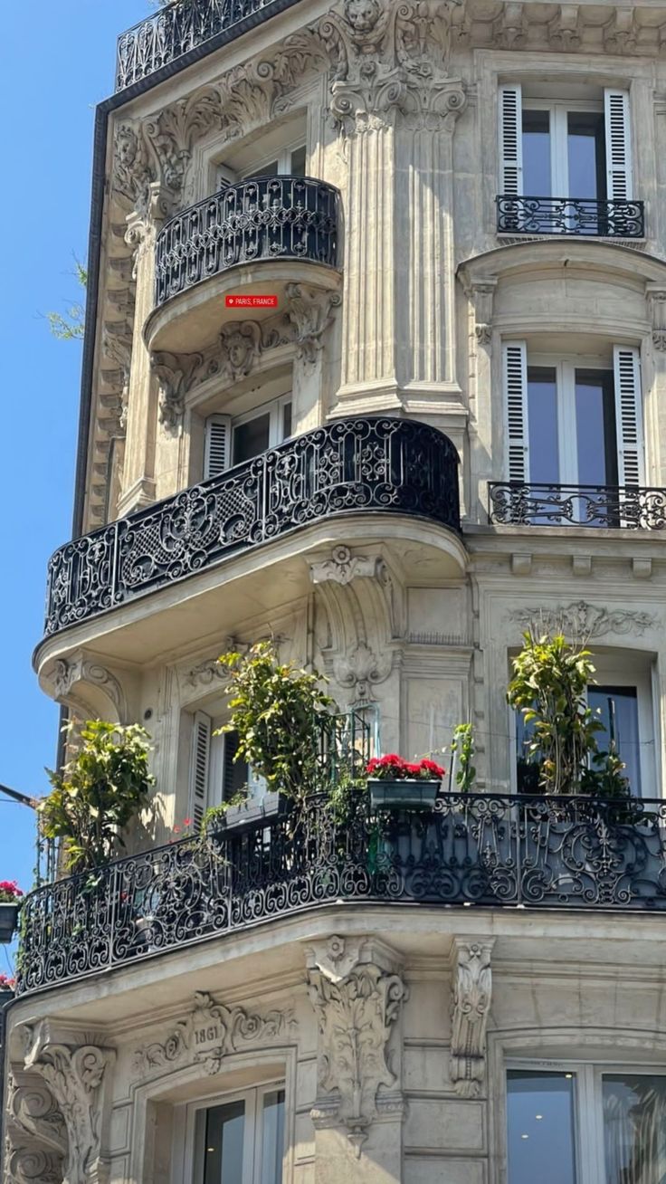 an ornate building with balconies and flower boxes on the balconys in paris, france