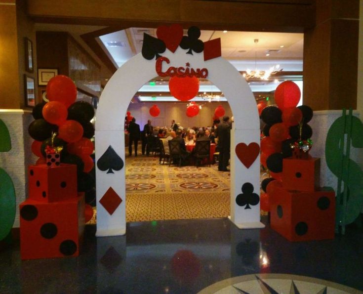 the entrance to casino is decorated with red and black balloons