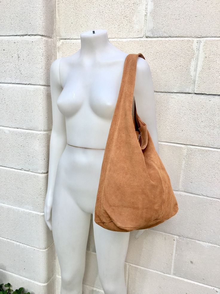 Slouch bag in soft brown suede. Soft leather shopper. LARGE tote leather bag in CAMEL BROWN with zipper. Natural genuine SUEDE leather. NOT LINED. Light tobacco color carry all bag. Width : 42cm - 16,5 in Height at the center: 34 cm - 13, 5 inc Total height : 65,5 cm - 26 inch This bag in different colors and other leather Bags by Good Times Barcelona: https://www.etsy.com/shop/goodtimesbarcelona?section_id=18820154&ref=shopsection_leftnav_10 Also available a matching camel brown suede bel a Light Brown Hobo Tote Bag, Light Brown Hobo Tote Bag For Errands, Light Brown Hobo Tote Bag For Shopping, Everyday Suede Hobo Bag, Light Brown Tote Hobo Bag For Shopping, Camel Tote Shoulder Bag For Errands, Suede Hobo Tote Bag For Everyday Use, Suede Hobo Travel Bag, Everyday Suede Hobo Tote Bag