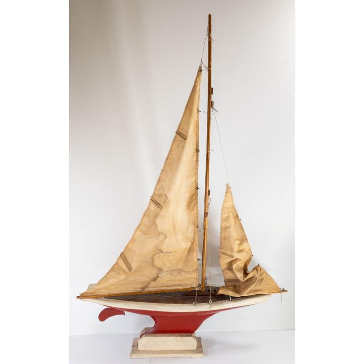 a model sailboat on a wooden stand