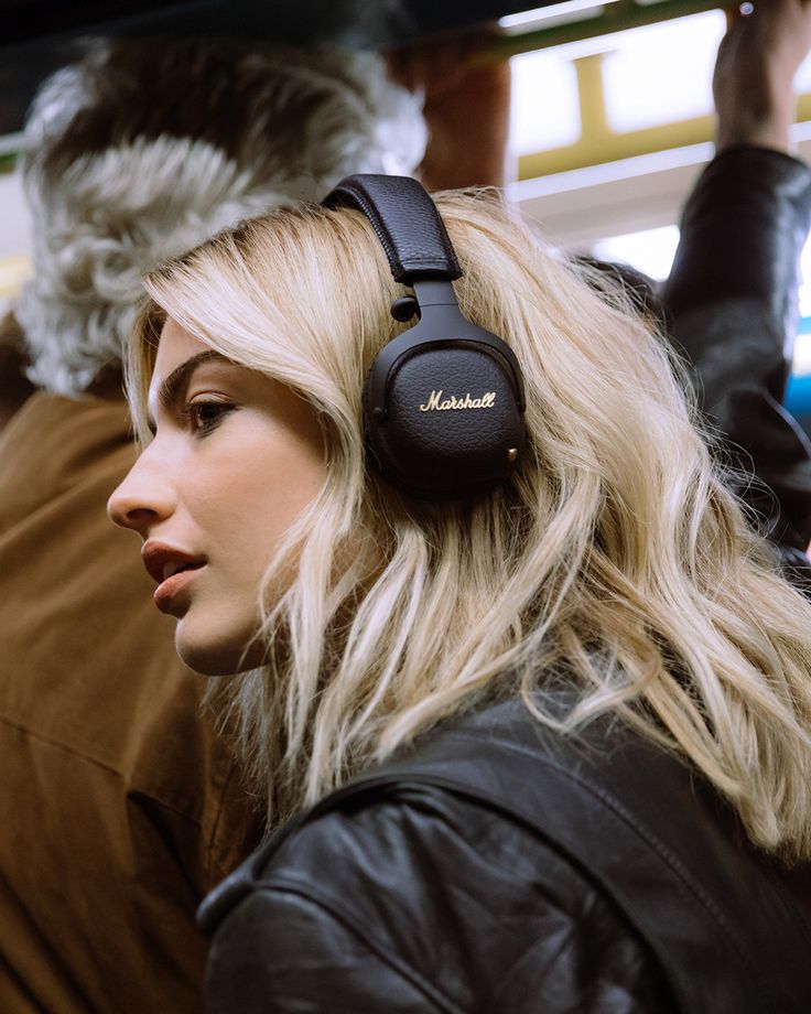 a blonde woman with headphones on her ears