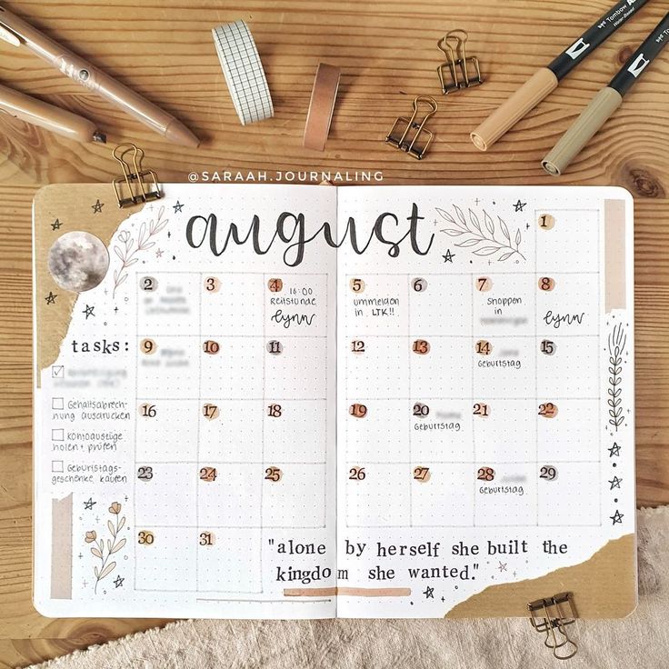 a planner with the words august written on it next to some pens and pencils