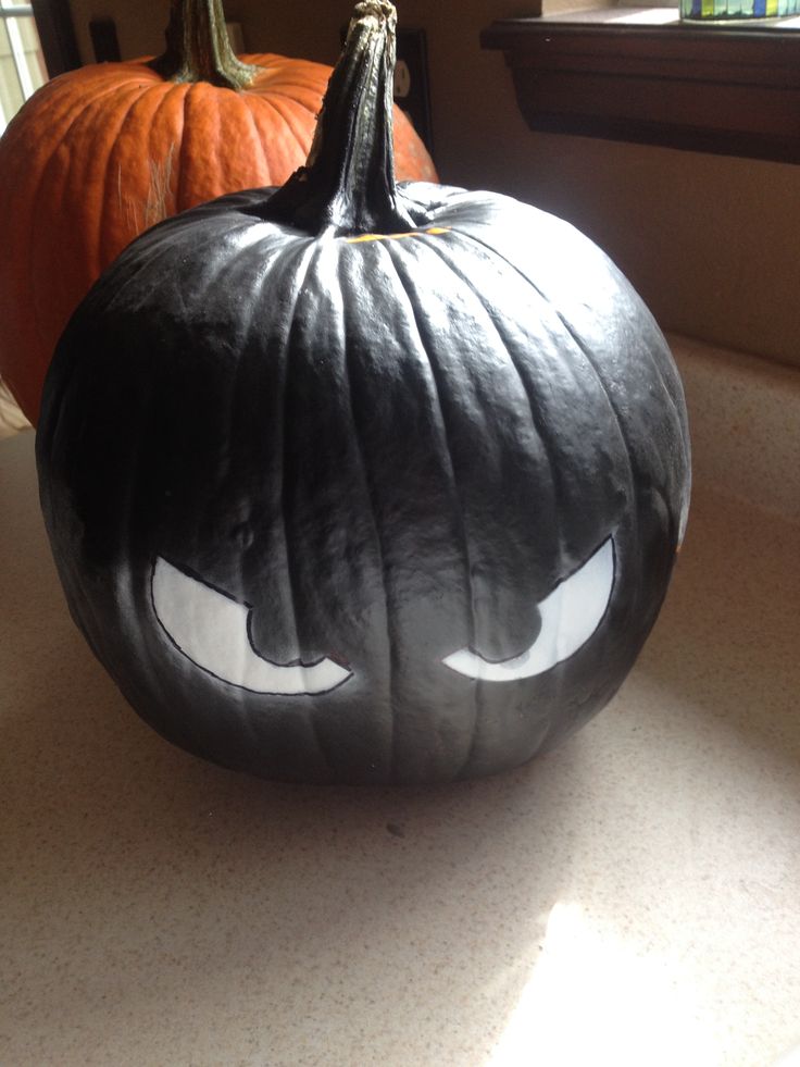 two pumpkins that have been painted to look like jack - o'- lanterns