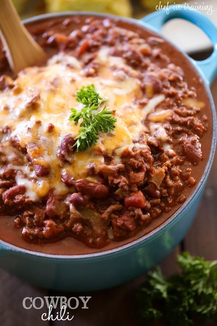 a blue pot filled with chili and cheese