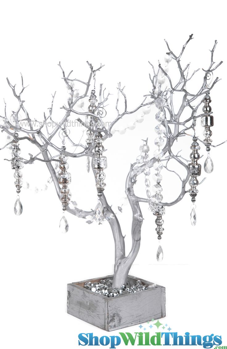 a silver tree with lots of beads hanging from it's branches on a white background