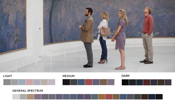 three people looking at paintings in an art museum with color swatches on the walls