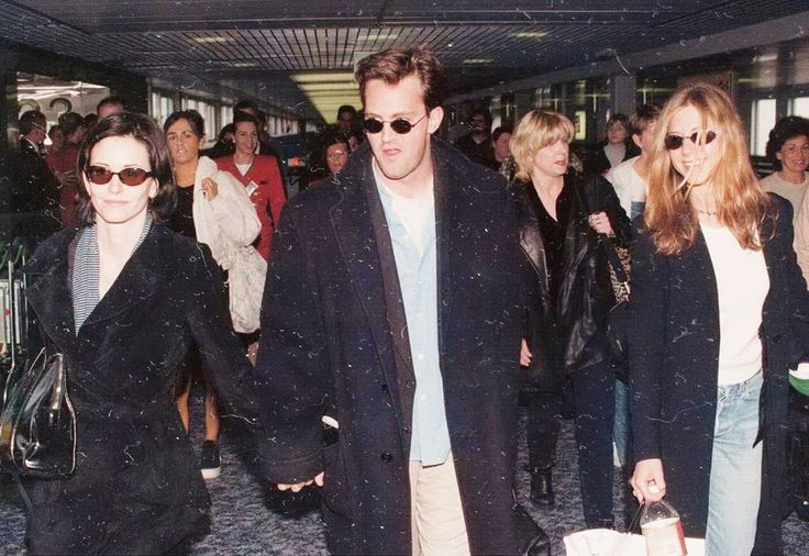 a group of people walking through an airport